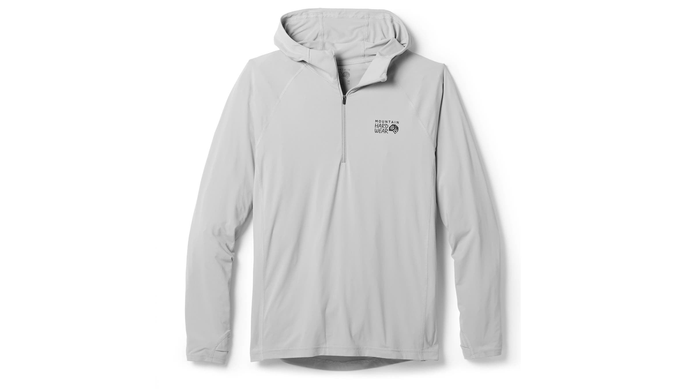 Light gray Mountain Hardwear half-zip long-sleeve sun hoody with a fitted hood. Delivers breathable sun protection during high-output fastpack efforts on exposed trails.